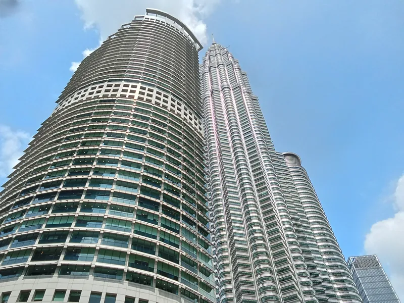 Menara Maxis and the Petronas Twin Towers from street level, KLCC