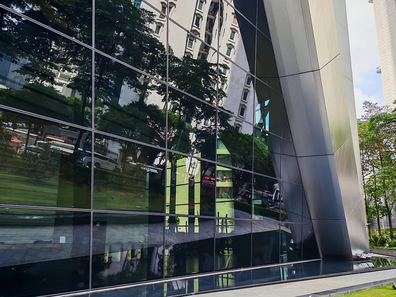 Glass curtain wall at the base of Menara Ilham